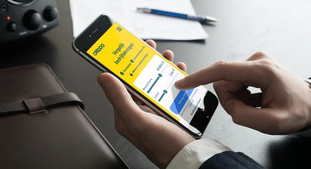 Creddo.com on a phone at a desk